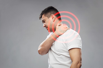 Image showing unhappy man suffering from neck pain