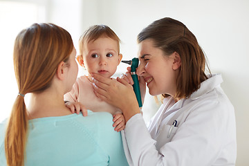 Image showing doctor with otoscope checking baby ear at clinic