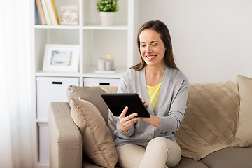 Image showing happy woman with tablet pc at home