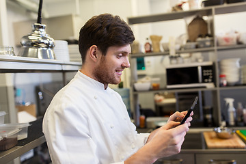 Image showing chef cook with tablet pc at restaurant kitchen