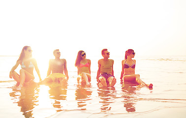 Image showing smiling friends in sunglasses on summer beach