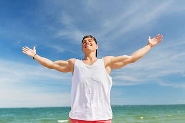 Image showing smiling young man on summer beach
