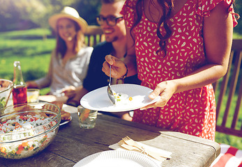 Image showing happy friends having dinner at summer garden party