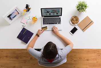 Image showing woman with laptop and credit card at table