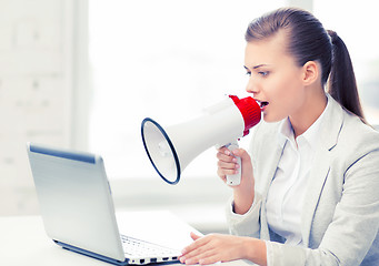 Image showing strict businesswoman shouting in megaphone