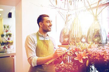 Image showing florist man with clipboard at flower shop