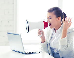 Image showing strict businesswoman shouting in megaphone