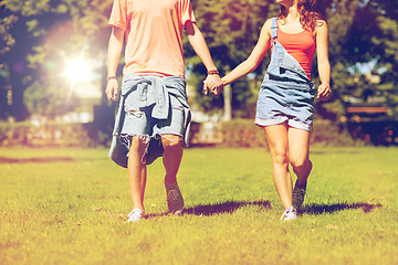 Image showing happy teenage couple walking at summer park