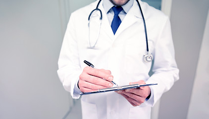 Image showing close up of doctor with clipboard at hospital