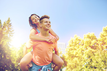 Image showing happy teenage couple having fun at summer park