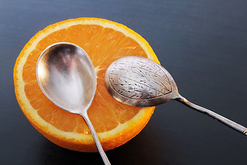 Image showing Juicy Orange and Two Vintage Spoons