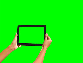 Image showing Young girl hand holding a tablet on green screen