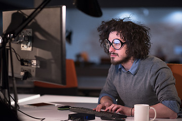 Image showing man working on computer in dark startup office