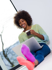 Image showing black woman in the living room on the floor