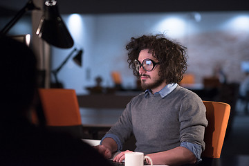 Image showing man working on computer in dark startup office