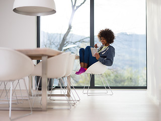 Image showing young African American woman in the living room