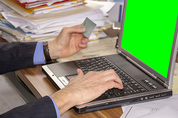 Image showing Business man shopping online, using laptop and credit card on gr