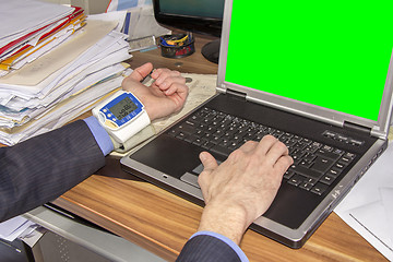 Image showing Businessman with high blood pressure due to stress caused by the