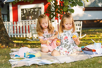 Image showing Two little girls sitting on green grass