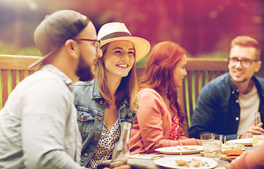 Image showing happy friends having dinner at summer garden party