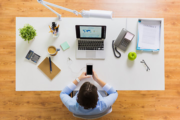 Image showing businesswoman with laptop and smartphone at office