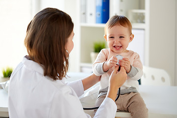 Image showing doctor with stethoscope and happy baby at clinic