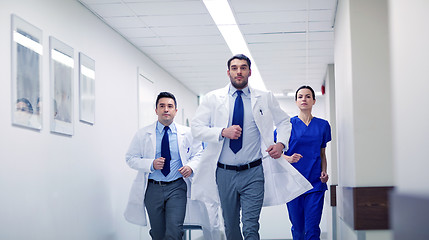 Image showing group of medics walking along hospital