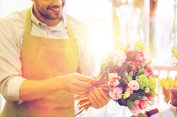 Image showing close up of florist man with bunch at flower shop