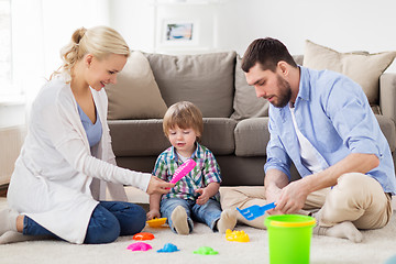 Image showing happy family playing with beach toys at home