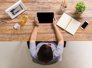 Image showing woman with tablet pc and notebook at office table