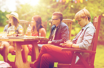 Image showing man with smartphone and friends at summer party