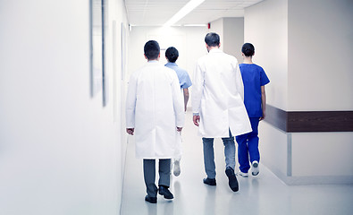 Image showing group of medics or doctors walking along hospital