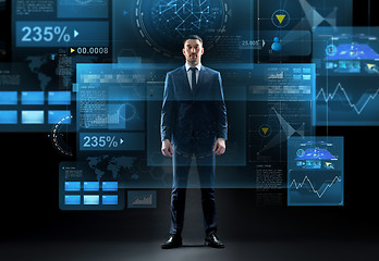 Image showing businessman in suit over virtual screens