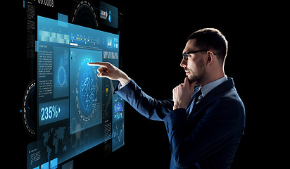 Image showing businessman with virtual screen over black