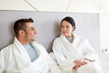 Image showing happy couple in bed at home or hotel room