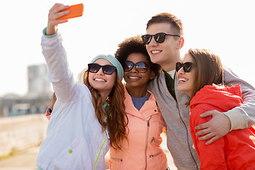 Image showing happy friends taking selfie by smartphone outdoors