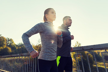 Image showing happy couple running outdoors