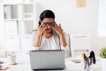 Image showing businesswoman rubbing tired eyes at office