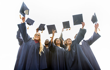 Image showing happy students throwing mortar boards up