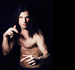 Image showing handsome young man with long hair naked torso on black backgroun