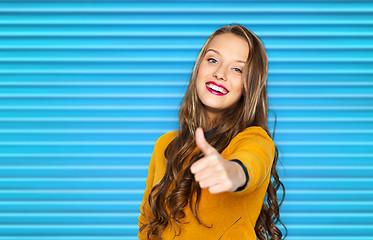 Image showing happy young woman or teen girl showing thumbs up