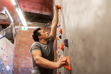 Image showing young man exercising at indoor climbing gym