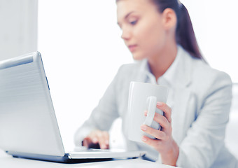 Image showing businesswoman with laptop in office