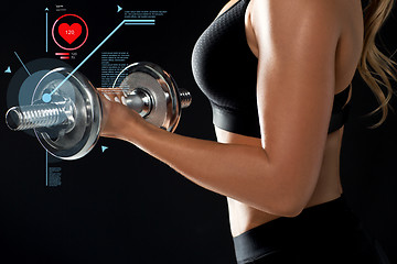 Image showing close up of woman with dumbbell and pulse