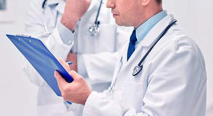 Image showing close up of doctors with clipboard at hospital