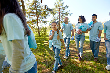 Image showing volunteers with garbage bags walking outdoors