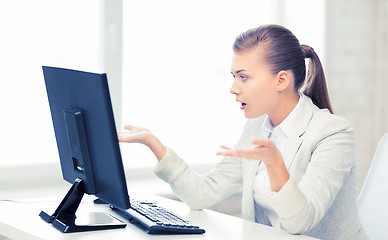 Image showing stressed student with computer in office