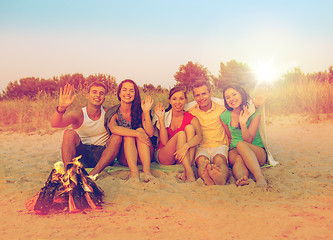 Image showing smiling friends in sunglasses on summer beach