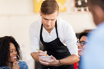 Image showing customers and waiter with notepad or restaurant