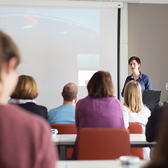 Image showing Woman giving presentation in lecture hall at university.